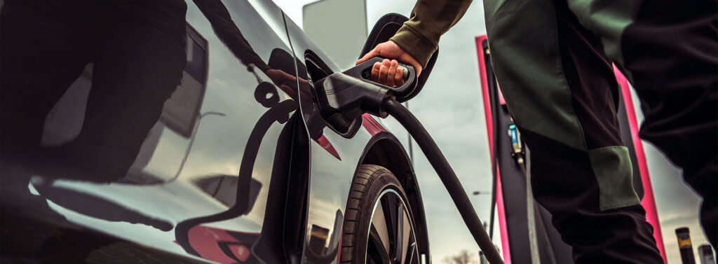 Man charging an Electric Vehicle