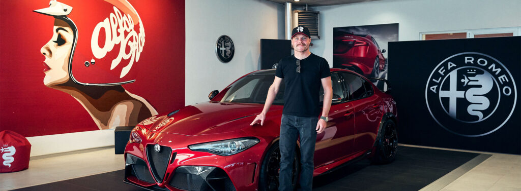 F1 Driver Valtteri Bottas stands beside this limited edition Alfa Romeo Giulia GTA high-performance car