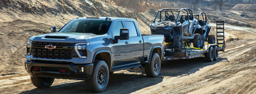 2024 Chevrolate Silverado truck pulling off-road vehicles