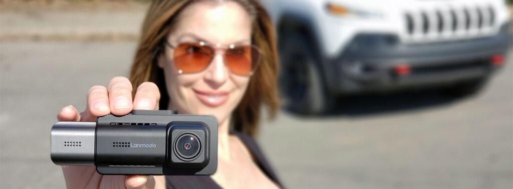 AutomotiveWoman aka Juliana Chiovitti holding the all-new Lanmodo D1 dashboard camera.