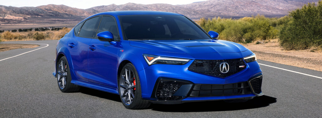 2024 Acura Integra Type S on road with blue exterior paint.