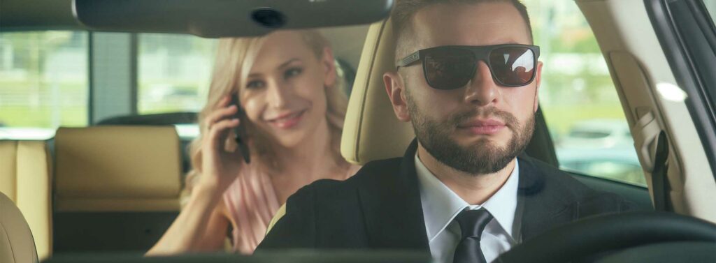 Woman sitting behind a ride share driver.