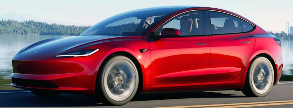 2024 Tesla Model 3 on the road in red.