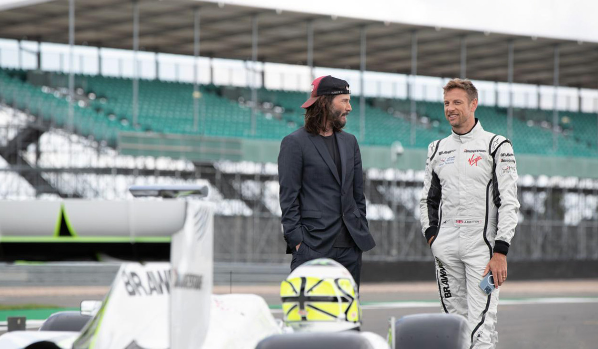 Keanu-Reeves-and-Jensen-Button-Stand-with-Brawn-GP-F1-Race-Car