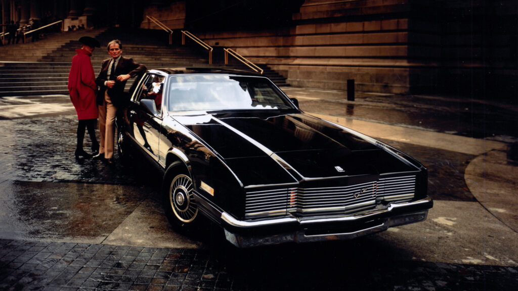 Pierre-Cardin-standing-with-Cadillac-Eldorado-by-AutomotiveWoman
