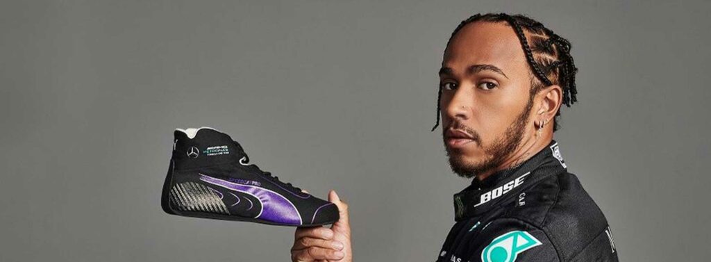 F1 Driver Lewis Hamilton poses with his Puma Motorsport shoe.