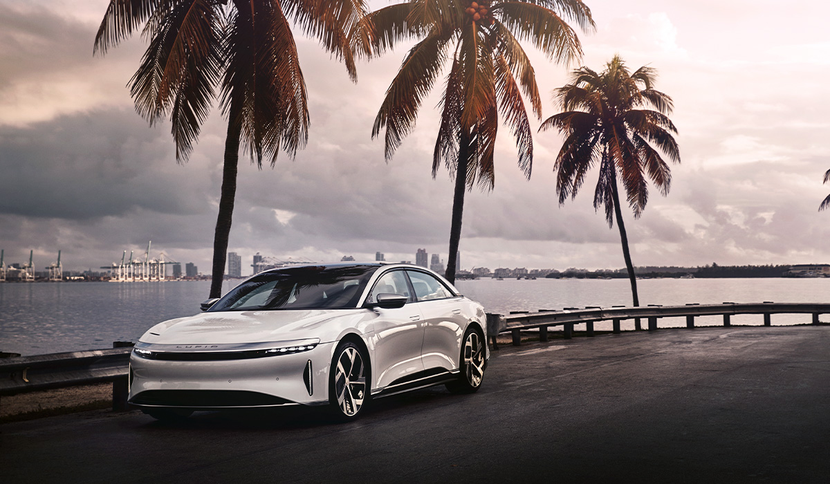 SAKS-and-Lucid-Motors-Collab-Palm-Tree-back-drop-shared-by-AutomotiveWoman.com